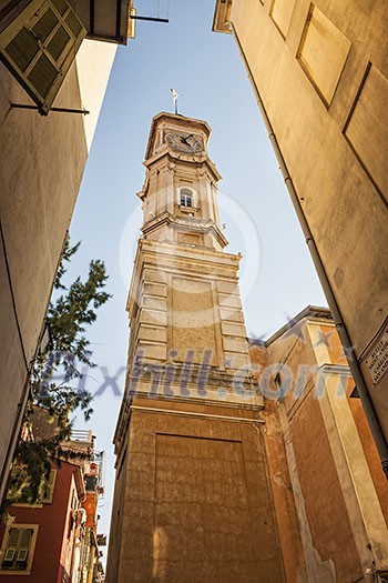 View of the clock tower of Saint Francois in Nice, France, from narrow street in old Nice. View of the clock tower of Saint Francois in Nice, France, from narrow street in old Nice.