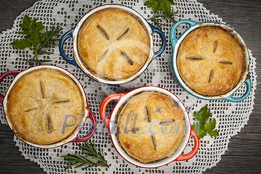 Four individual size meat pot pies from above