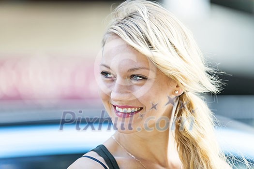 Candid portrait of young blonde woman smiling with copy space