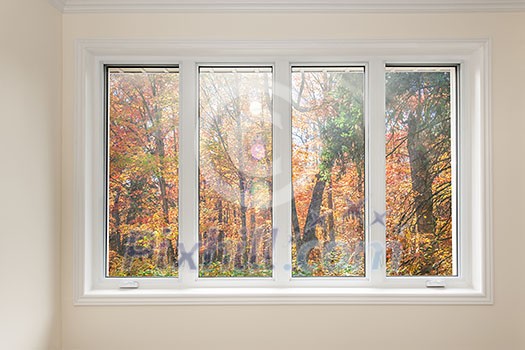 Large four pane window looking on colorful fall forest