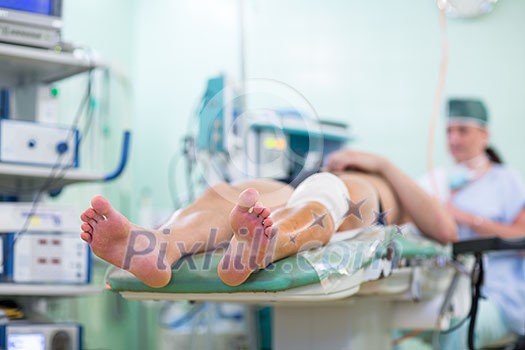 Feet of a patient ready for a surgery in a surgery room (color toned image; shallow DOF)