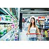 Beautiful young woman shopping in a grocery store/supermarket (color toned image)