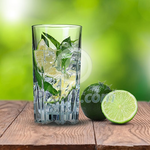 mohito cocktail with lime on wooden table against green natural background mohito cocktail with lime on wooden table against green natural background