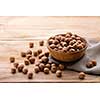 Hazelnuts in bowl on wooden table