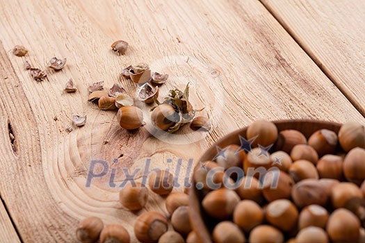 Hazelnuts in bowl on wooden table Hazelnuts in bowl on wooden table