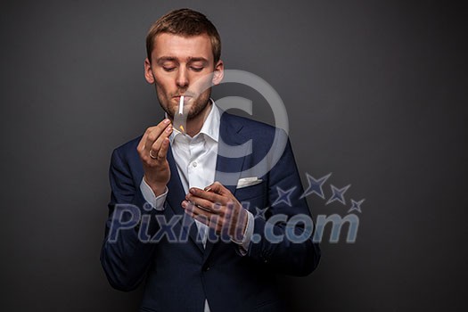 portrait of handsome businessman with cigarette on black portrait of handsome businessman with cigarette on black