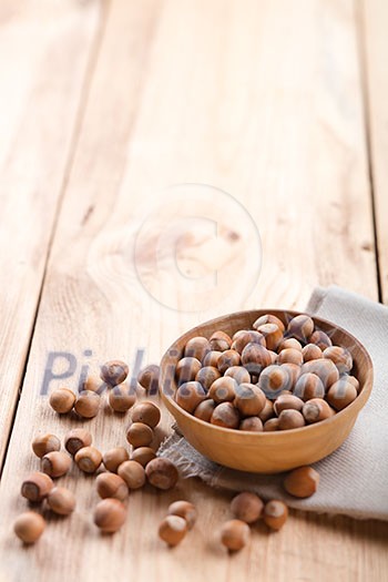 Hazelnuts in bowl on wooden table
