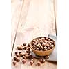 Hazelnuts in bowl on wooden table