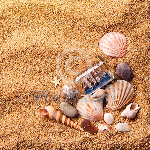 background of various shells and small ship in bottle on sand. Top view background of various shells and small ship in bottle on sand. Top view