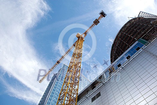 Modern building under construction against blue sky