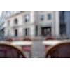 Background of blurred cafe on street of european city. Tables and chairs outside in natural bokeh