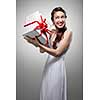 Young surprised smiling woman holding gift