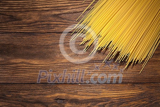 italian spaghetti on wooden background. Top view