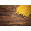 italian spaghetti on wooden background. Top view