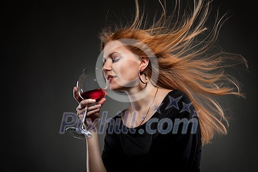 woman with red hair holding wine glass
