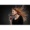 woman with red hair holding wine glass