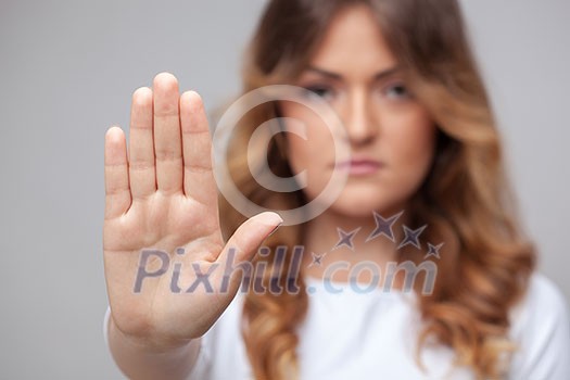 female hand stop sign on grey background