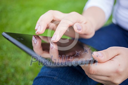 Woman using digital tablet PC in the park