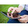 Woman using digital tablet PC in the park