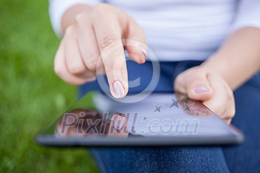 Woman using digital tablet PC in the park
