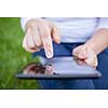 Woman using digital tablet PC in the park