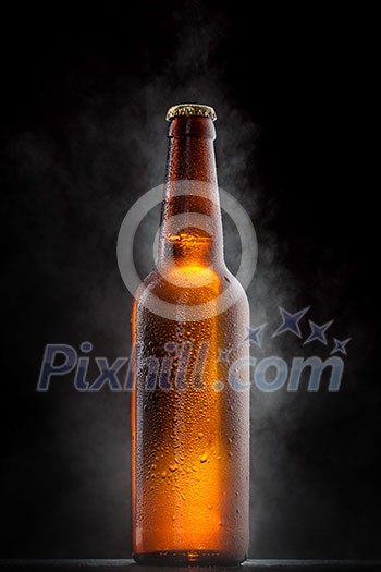 Cold beer bottle with drops, frost and vapour on black Cold beer bottle with drops, frost and vapour on black