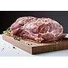 Photo of raw meat. Pork neck with herbs and green thyme on wooden board