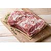 Photo of raw meat. Pork neck with herbs and green thyme on wooden board. Top view