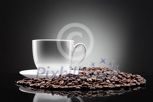 white cup with coffee beans on black