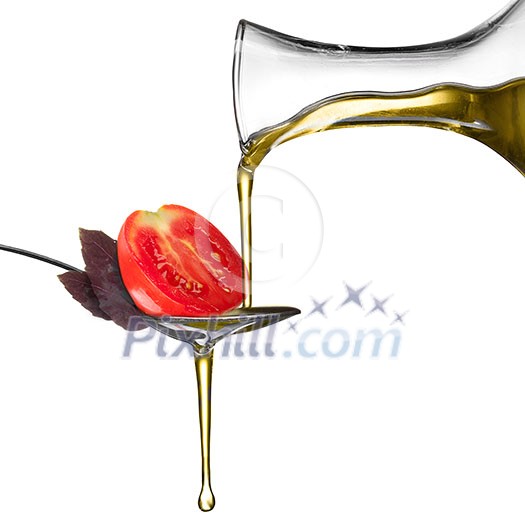Pouring oil on spoon with basil and tomato isolated on white Pouring oil on spoon with basil and tomato isolated on white