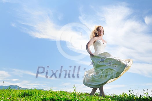 happy young beautiful bride after wedding ceremony event have fun outdoor on meadow at sunset