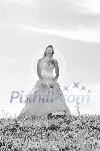 happy young beautiful bride after wedding ceremony event have fun outdoor on meadow at sunset happy young beautiful bride after wedding ceremony event have fun outdoor on meadow at sunset