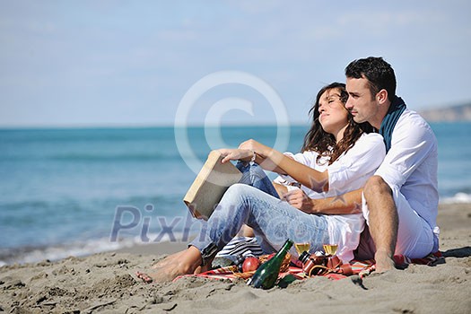 happy young couple enjoying picnic on the beach and have good time on summer vacations happy young couple enjoying picnic on the beach and have good time on summer vacations