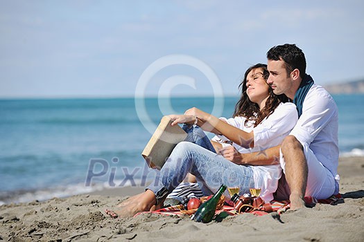 happy young couple enjoying  picnic on the beach and have good time on summer vacations