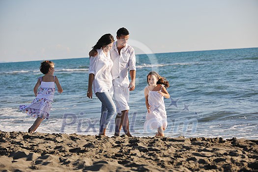 happy young family in white clothing have fun at vacations on beautiful beach happy young family in white clothing have fun at vacations on beautiful beach