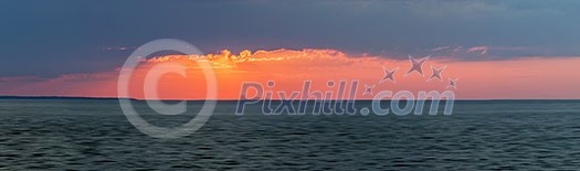 Panoramic sunset with red dramatic  sky over Atlantic Ocean in Prince Edward Island, Canada