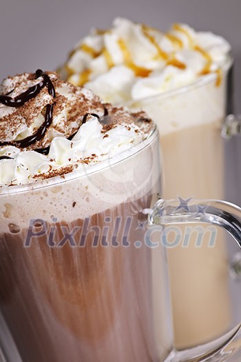 Hot chocolate and coffee latte beverages with whipped cream Hot chocolate and coffee latte beverages with whipped cream