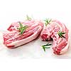 Two raw fresh lamb chops with rosemary herb