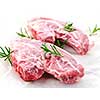 Two raw fresh lamb chops with rosemary herb
