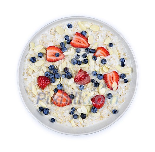 Bowl of hot oatmeal breakfast cereal with fresh berries from above