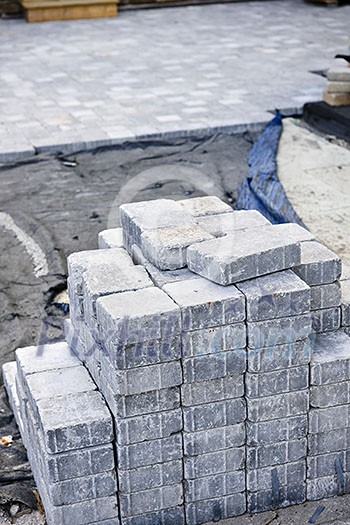 Stacks of interlocking stones for installing driveway landscaping Stacks of interlocking stones for installing driveway landscaping