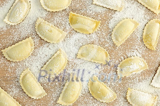 Uncooked ravioli pasta prepared and ready for cooking from above Uncooked ravioli pasta prepared and ready for cooking from above