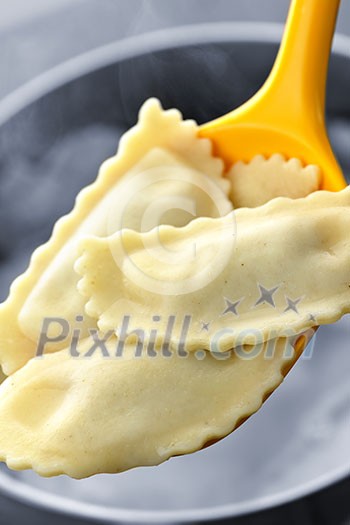 Cooked ravioli lifted from pot on spoon Cooked ravioli lifted from pot on spoon