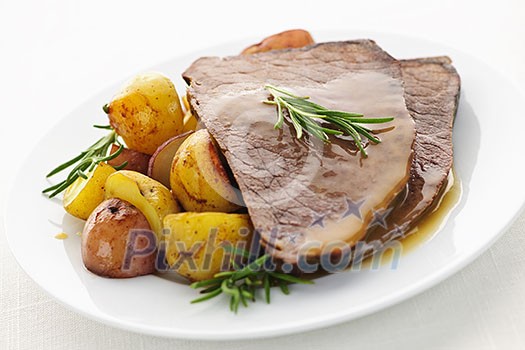 Serving of roast beef and roasted potatoes meal Serving of roast beef and roasted potatoes meal