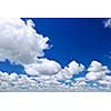 Background of blue sky with white cumulus clouds