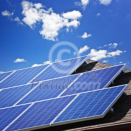 Array of alternative energy photovoltaic solar panels on roof