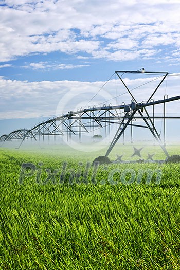 Industrial irrigation equipment on farm field in Saskatchewan, Canada Industrial irrigation equipment on farm field in Saskatchewan, Canada