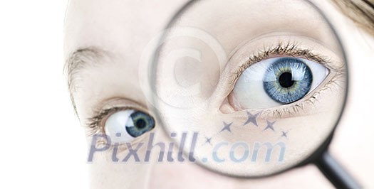 Female blue eye looking through magnifying glass close up