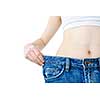 Fit young woman in loose jeans after losing weight isolated on white