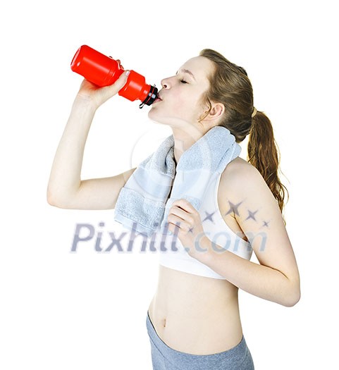 Happy fit young woman drinking from water bottle after workout Happy fit young woman drinking from water bottle after workout